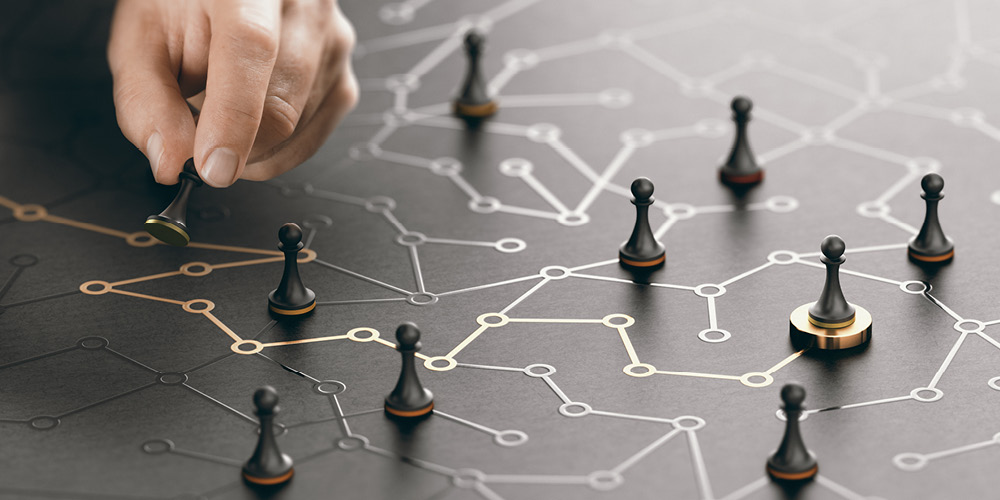 Hand moving pawn on a conceptual maze.