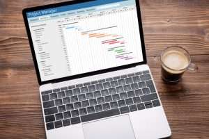 Photo of a tradeshow planning Gantt chart on a laptop.