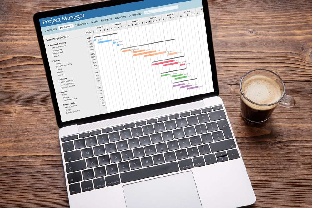 Photo of a tradeshow planning Gantt chart on a laptop.